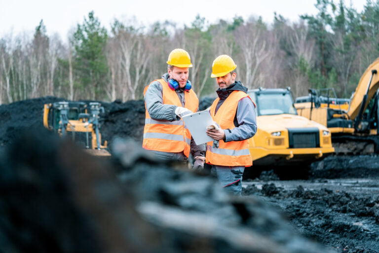 Workers in quarry looking at a plan